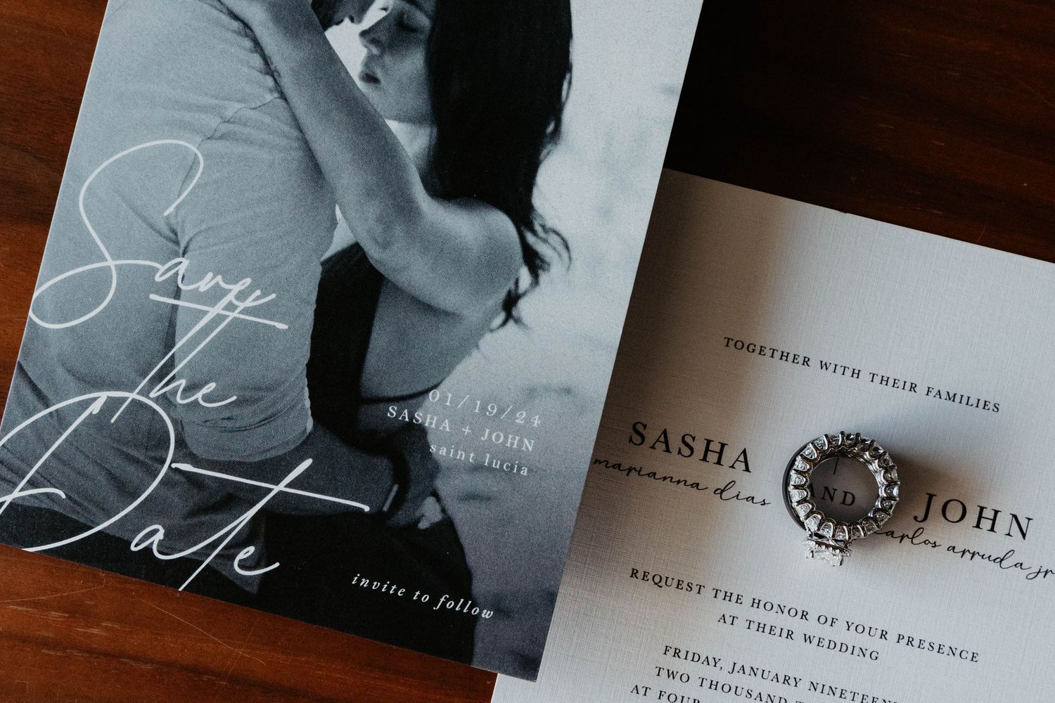 Black and white save the date card with couple photo beside elegant wedding invitation for Sasha and John with decorative ring.