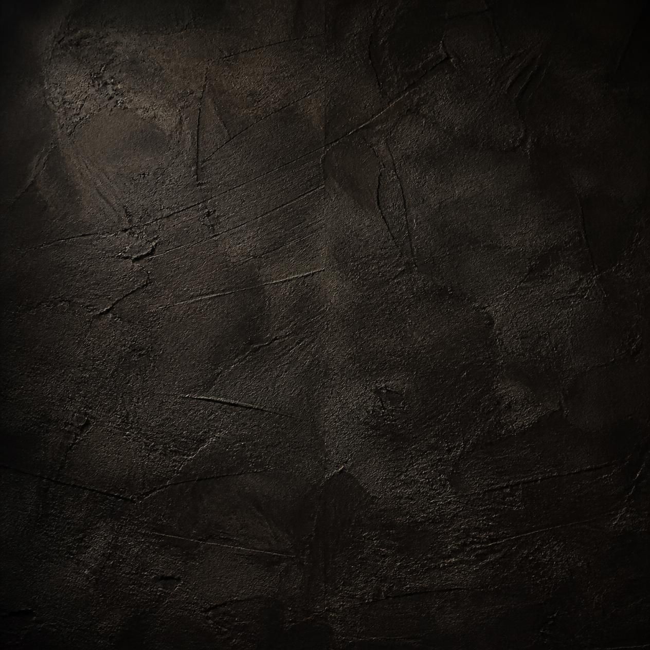 Dark textured grunge wall background with rough black surface and subtle scratches for dramatic design use.