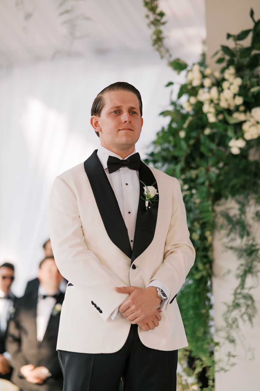 Groom reacting as Mar walks down the aisle during their wedding ceremony at Casa Santo Domingo in Antigua Guatemala.