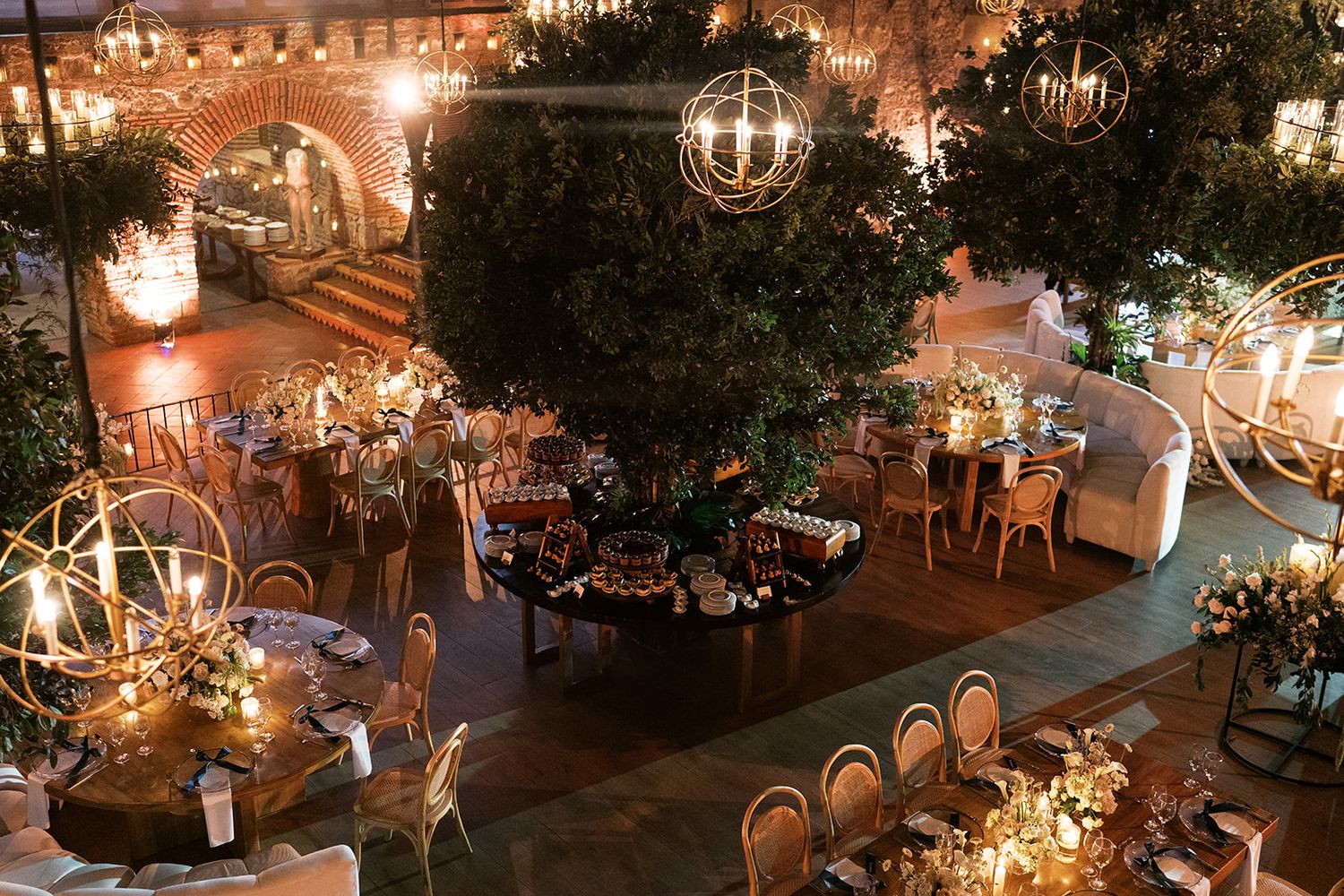 Candlelit wedding reception with suspended greenery at Centro de Convenciones at Casa Santo Domingo.