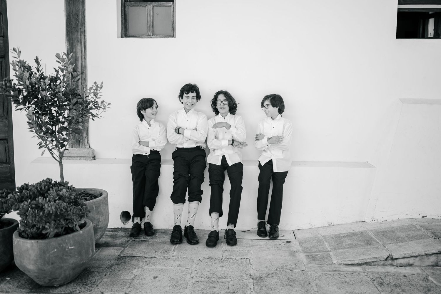 Kids in a wall at a wedding in Antigua Guatemala showing socks in black and white photo