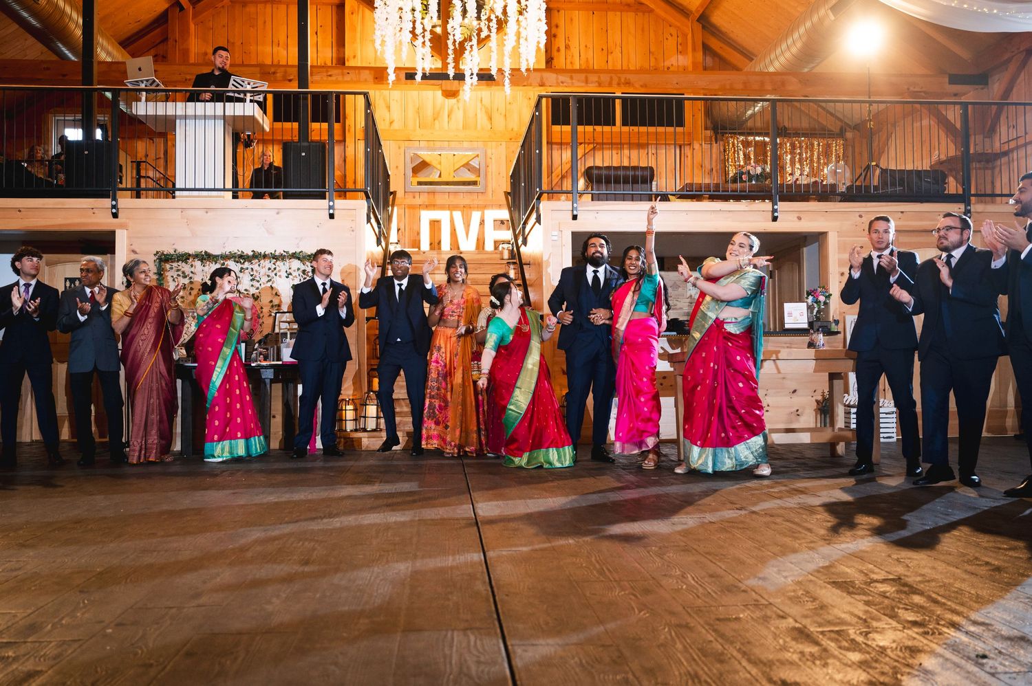 Wedding celebration in a rustic barn venue with decorative lighting and festive atmosphere at Fortune Valley Manor in Saugerties, NY.