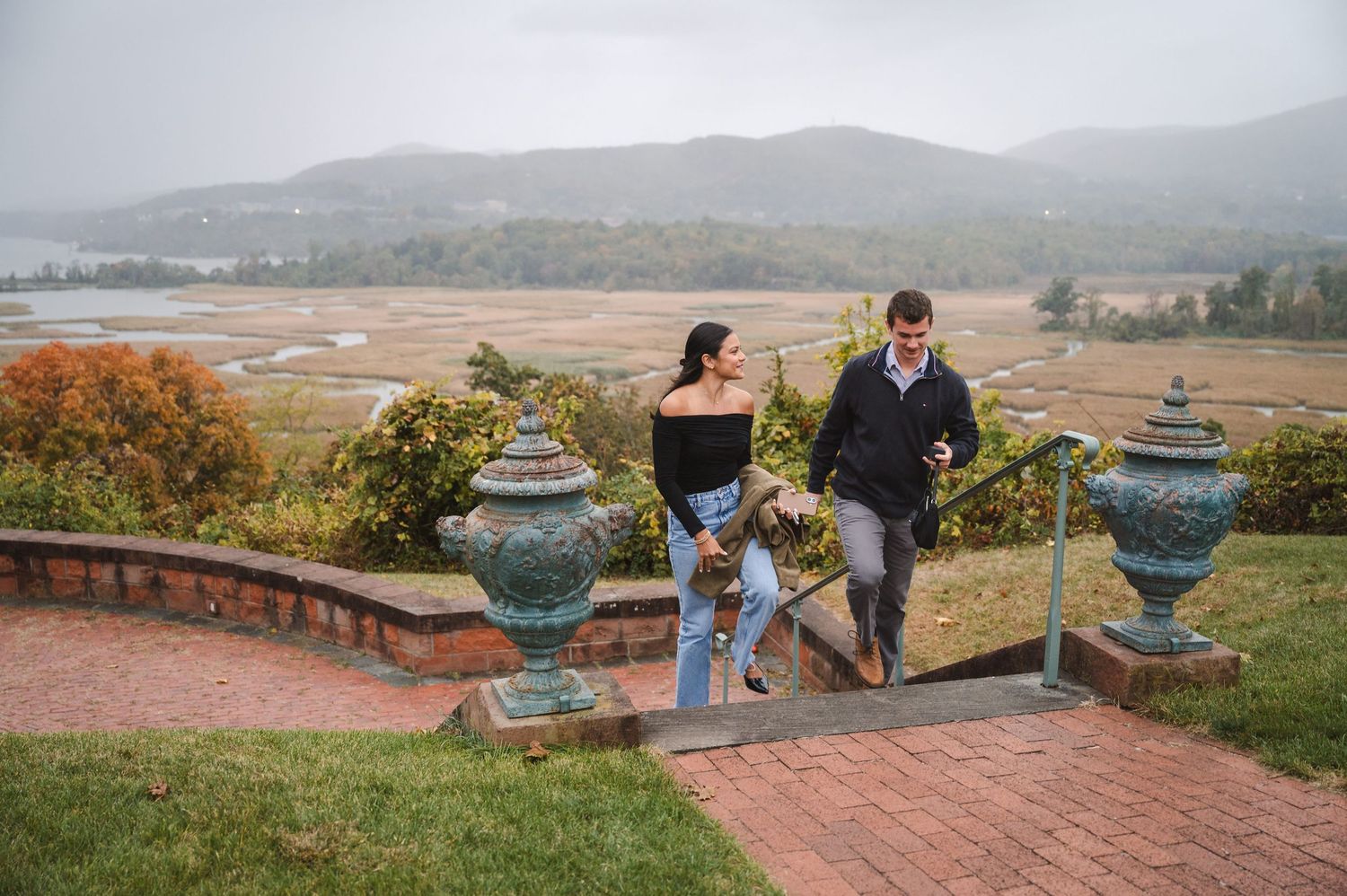 Couple walking with a view of Hudson River at Boscobel House in Garrison, NY in Hudson Valley.