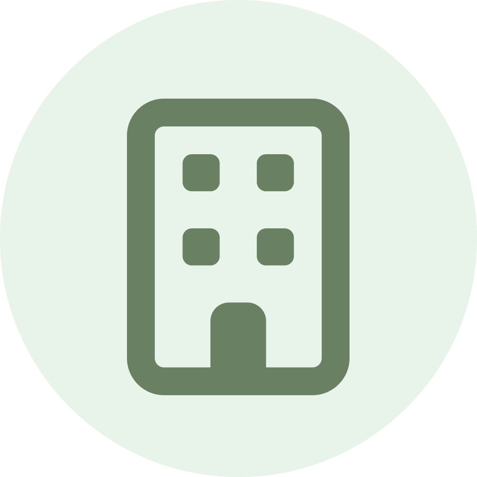 Simple line icon of a small apartment building or office in green within a light mint circular background.