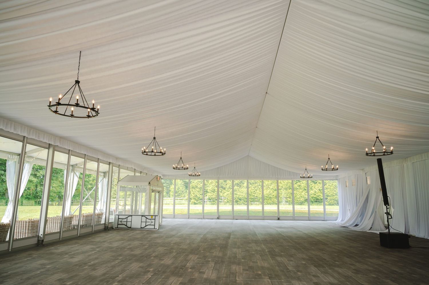 White tent wedding reception space with chandeliers and draped fabric ceilings at Boscobel House in Garrison, NY in the Hudson Valley.