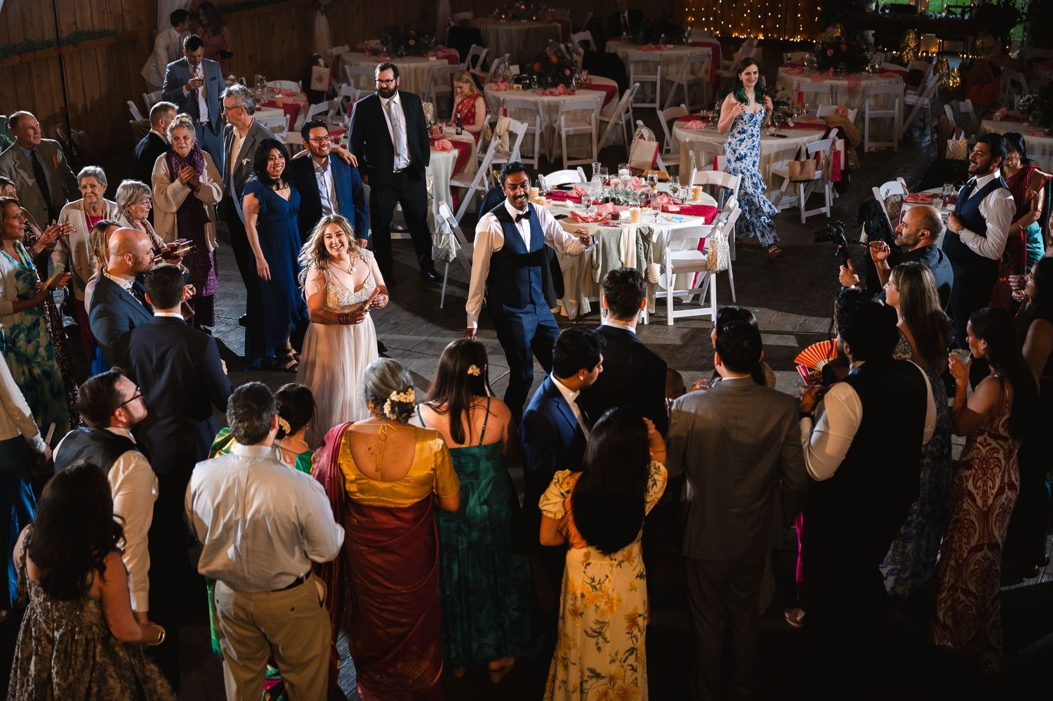Wedding celebration with guests gathered in a circle on the dance floor of a rustic barn venue at Fortune Valley Manor in Saugerties, NY.