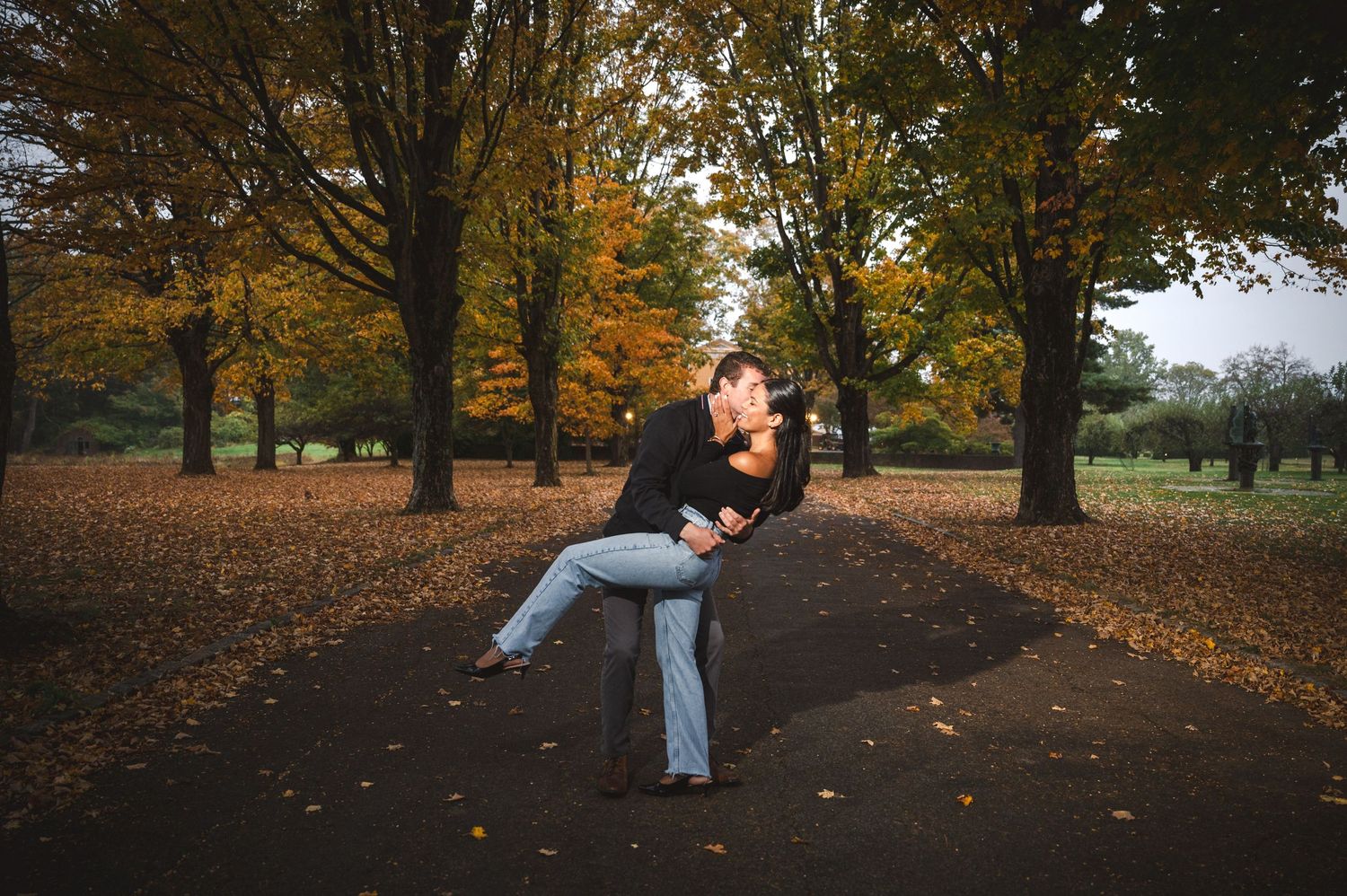 A newly engaged couple against scenic tree foliage in the background at Boscobel House & Gardens in Garrison, New York