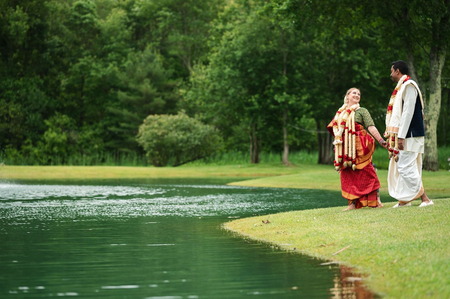 Couple wedding photo along a peaceful lakeside setting with green landscaping at Fortune Valley Manor in Saugerties, NY in the Hudson Valley