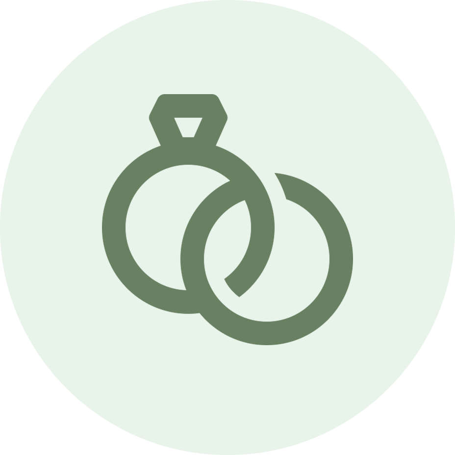 Simple green icon of two interlocked wedding rings in a circular design on mint background.