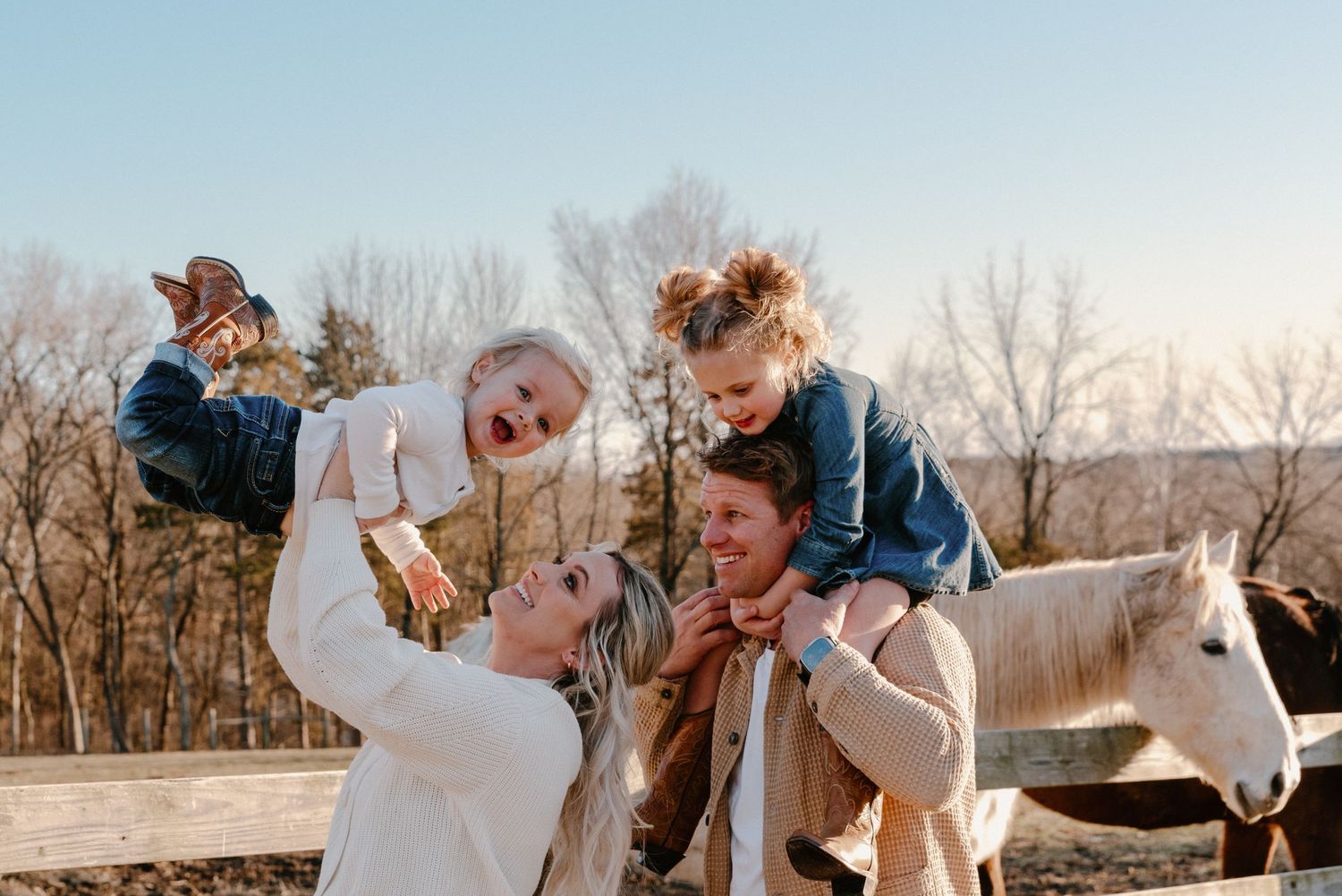 Playful outdoor photoshoot with couple and flowing fabric in winter landscape.