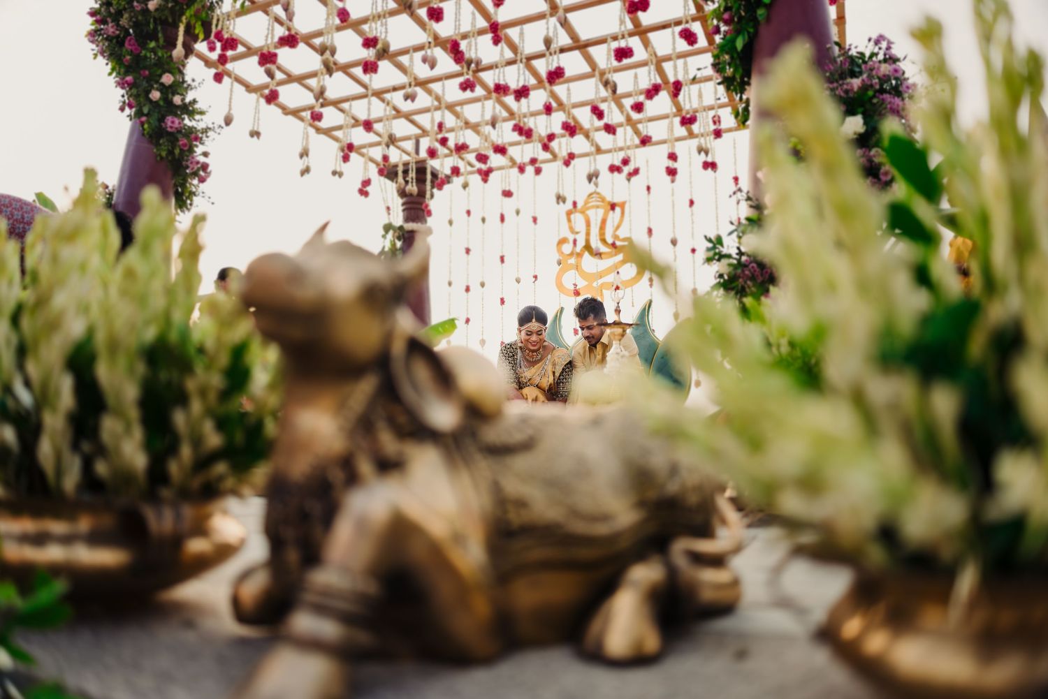 A string of red lanterns hangs overhead at an outdoor Asian market creating a festive atmosphere.