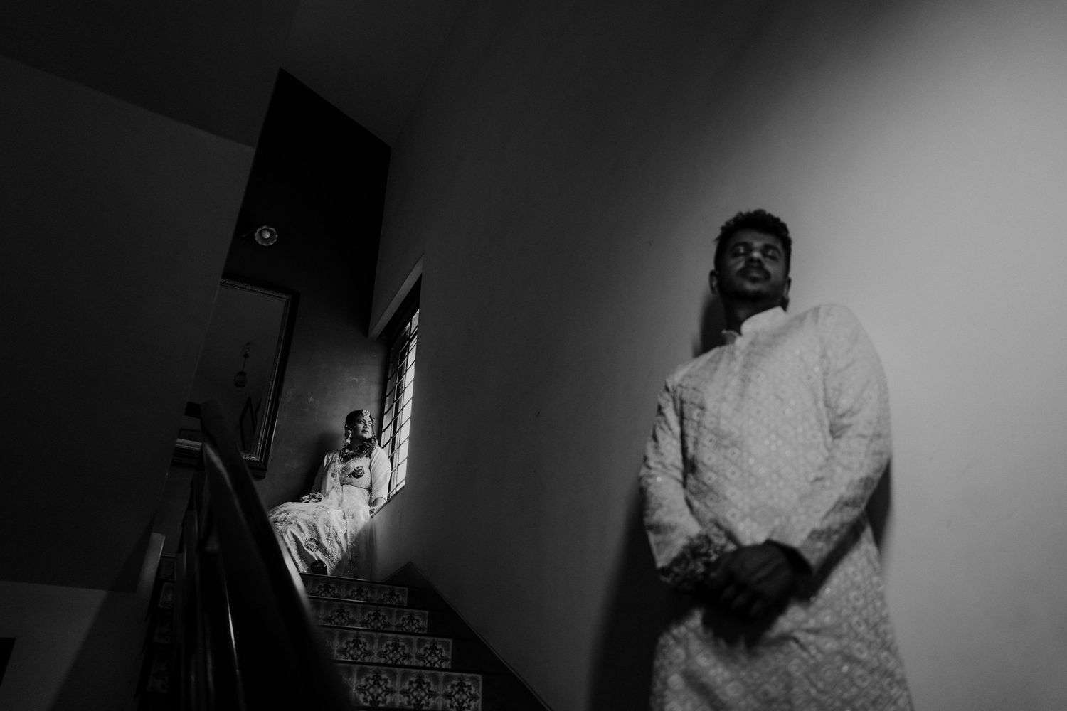 A series of black and white photos showing a person in a white shirt moving through different positions.