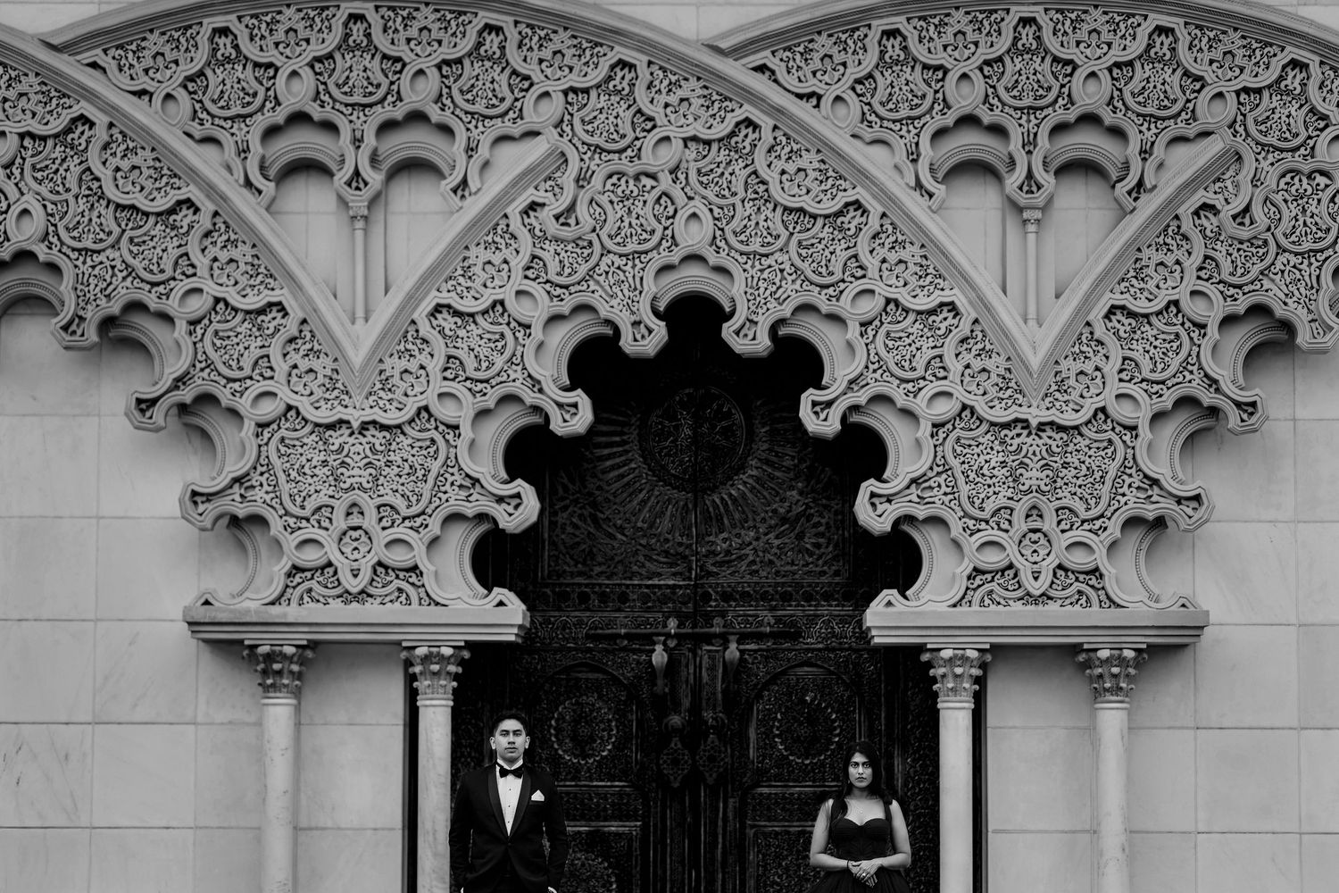 Ornate Victorian architectural details show white decorative trim and molding against a light colored wall.