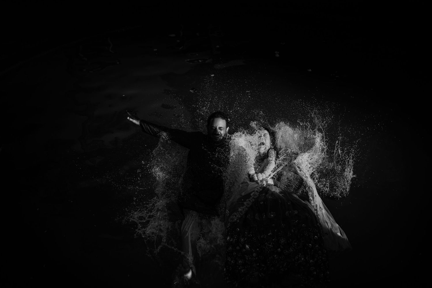A series of black and white abstract photographs showing motion blur and ghostly light trails in darkness.
