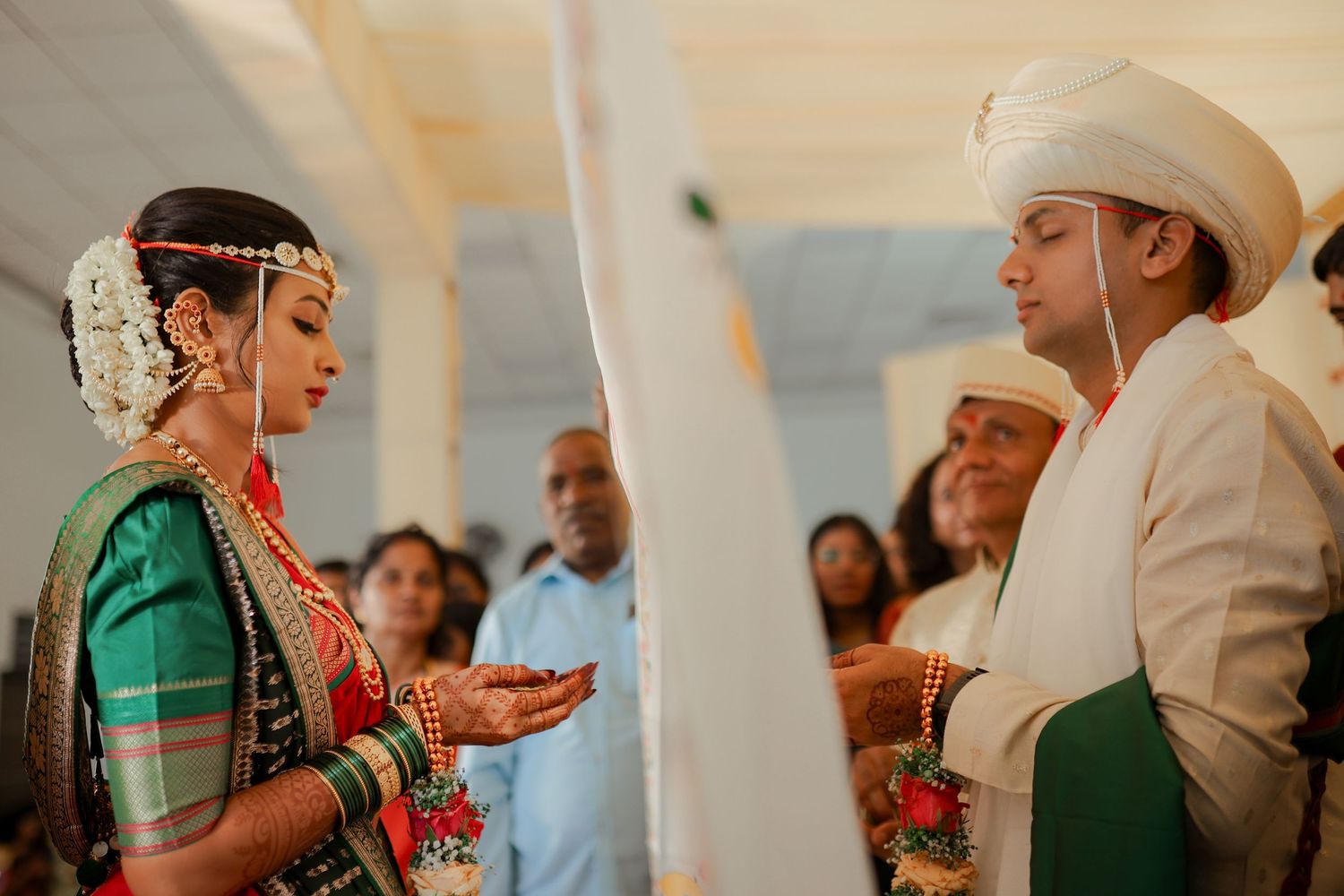 A series of candid moments captured at an Indian wedding ceremony with people wearing traditional attire and decor.