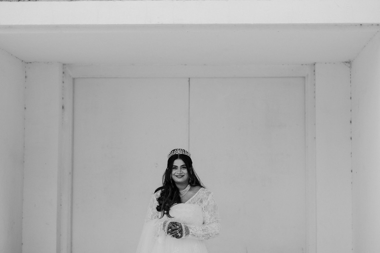 Black and white photo series showing a person in various poses against a white wall.