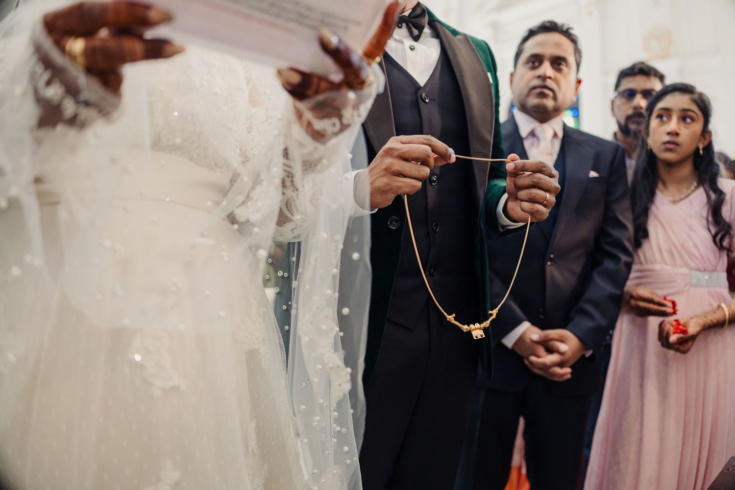 Wedding guests gathered together during a celebration ceremony indoors.