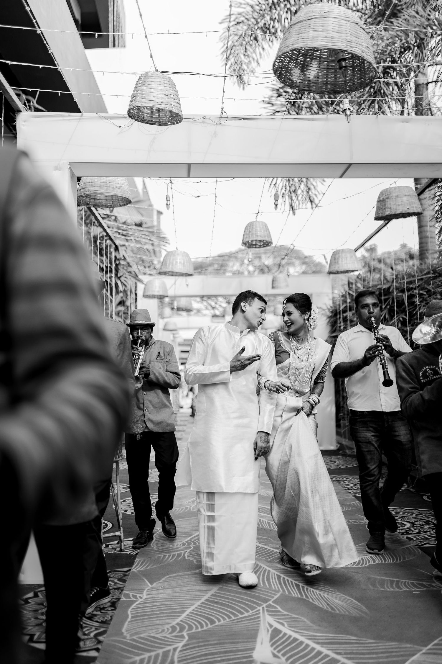 Black and white photo sequence showing a couple's first dance at their wedding reception on a patterned dance floor.