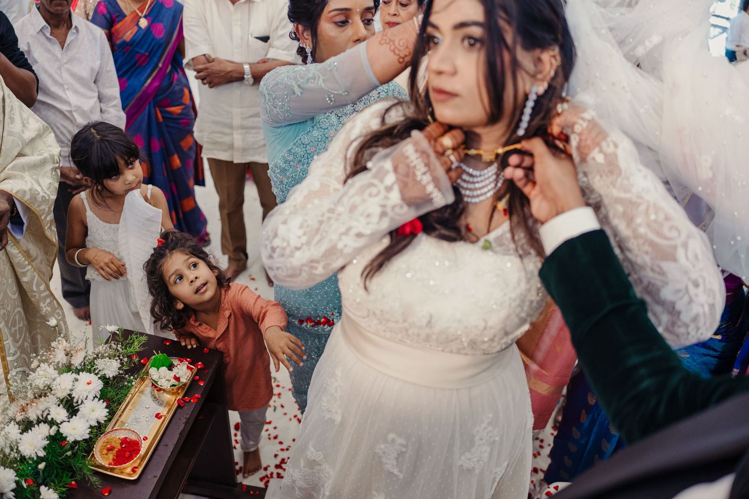 Wedding celebration with guests dancing and socializing in an elegant indoor venue.