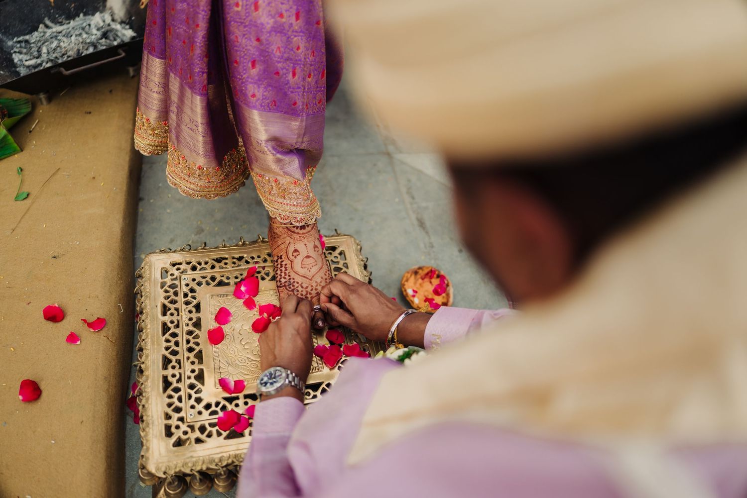 Wedding guests sprinkle colorful rose petals during a traditional ceremony celebration.