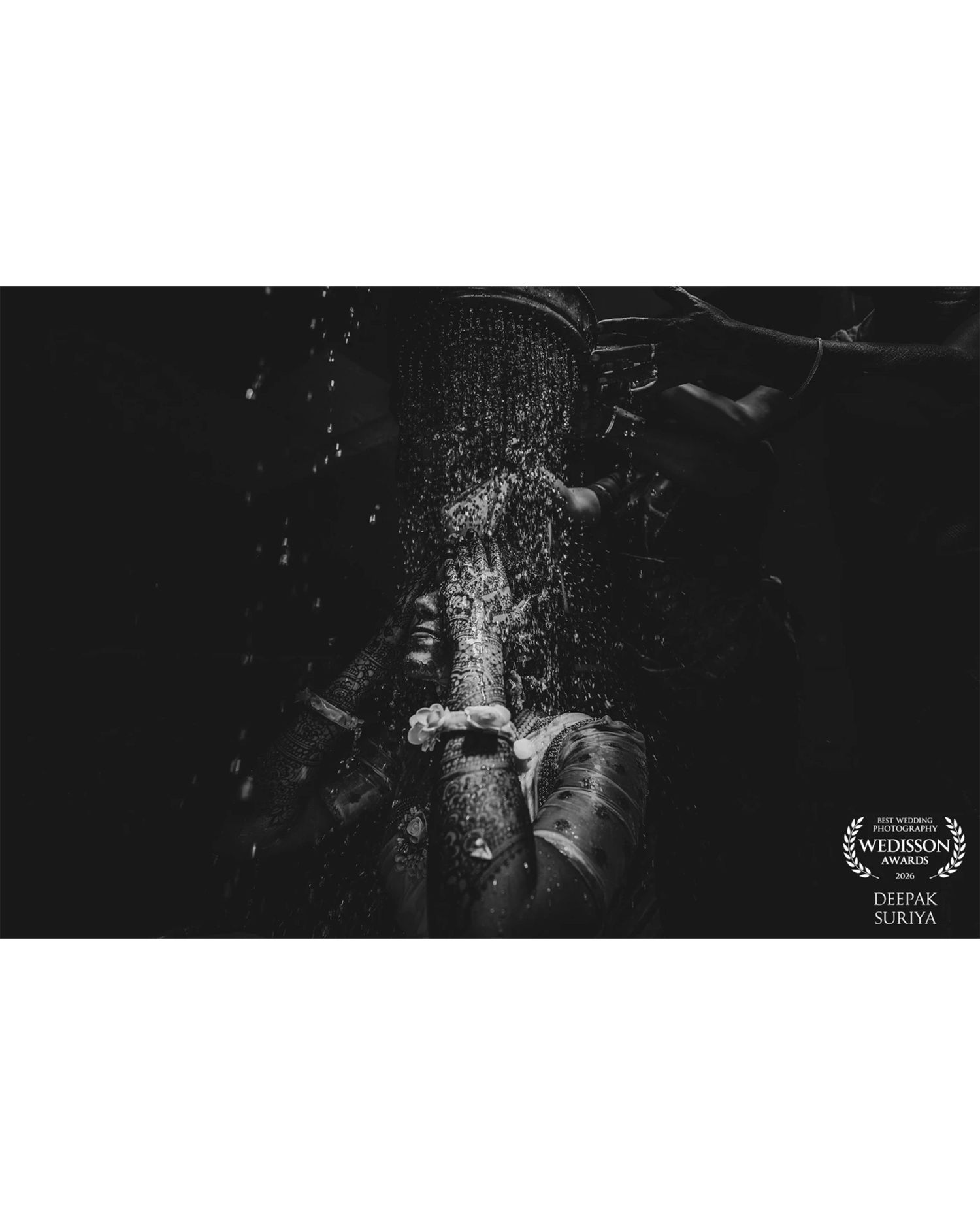 Black and white wedding photo of hands under cascading water, captured by Deepak Suriya, Wedisson Award winner.
