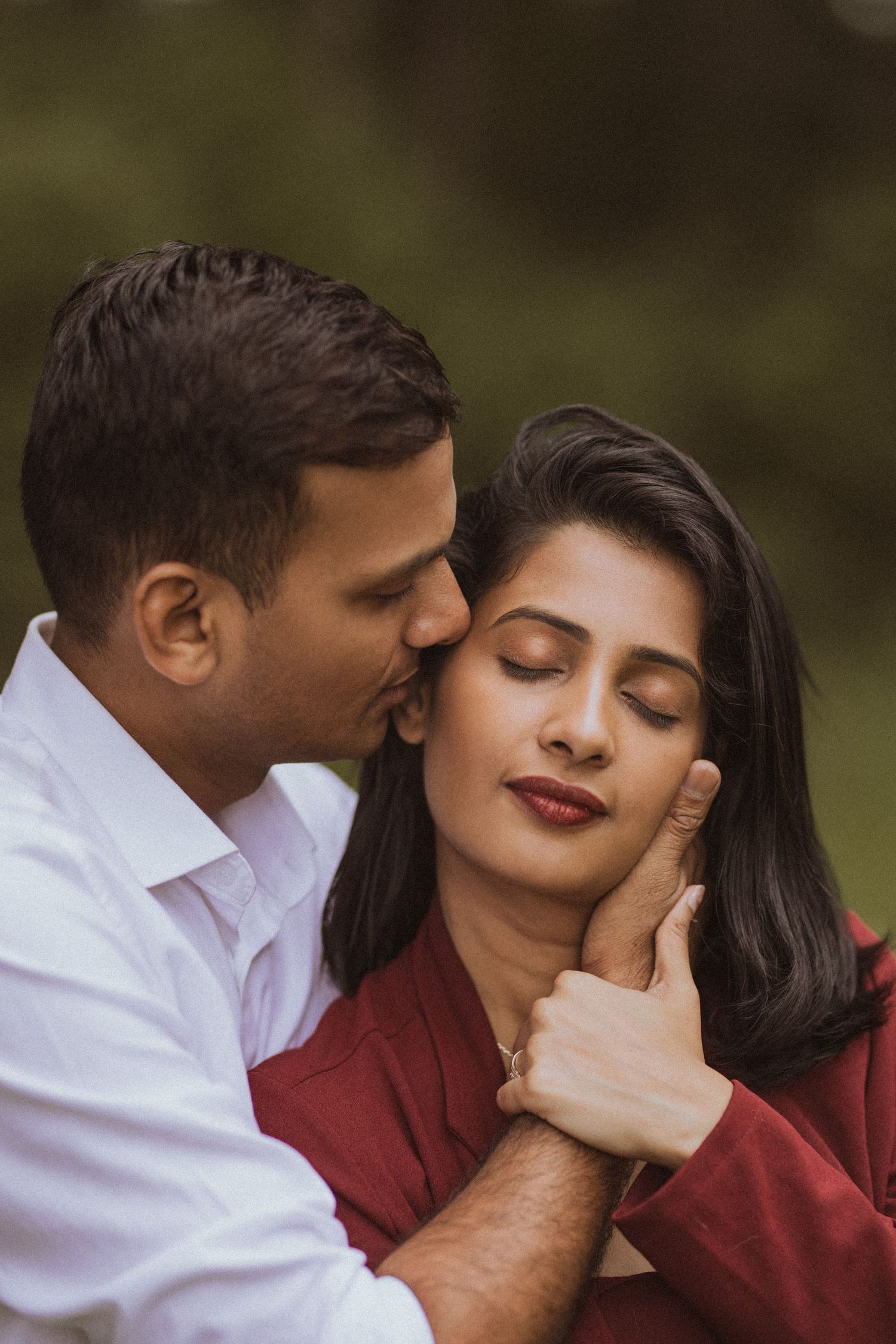 A romantic couple in burgundy and white outfits share intimate moments in a series of tender outdoor photographs.