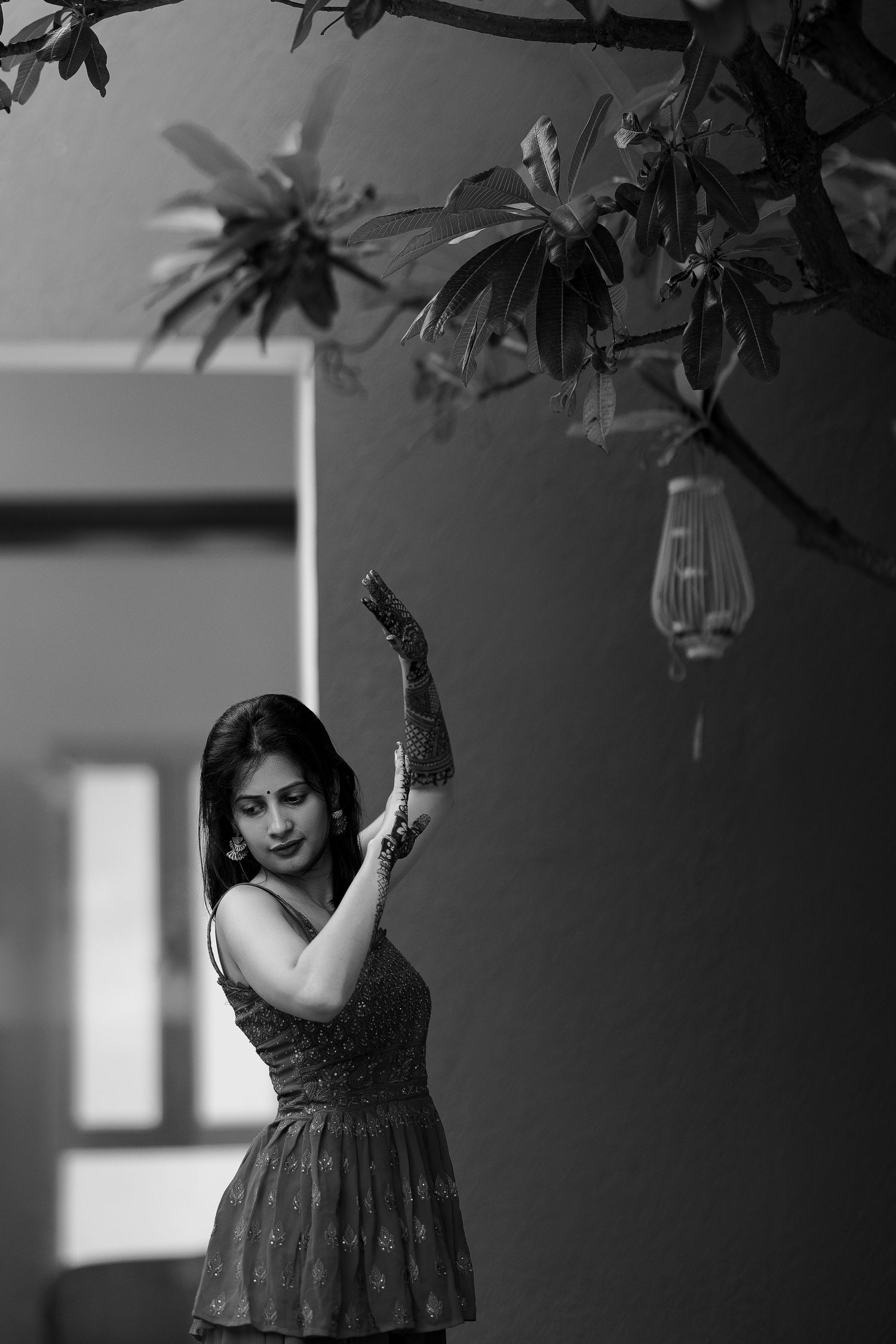 Black and white artistic portrait series showing person in flowing dress posing gracefully against light background.