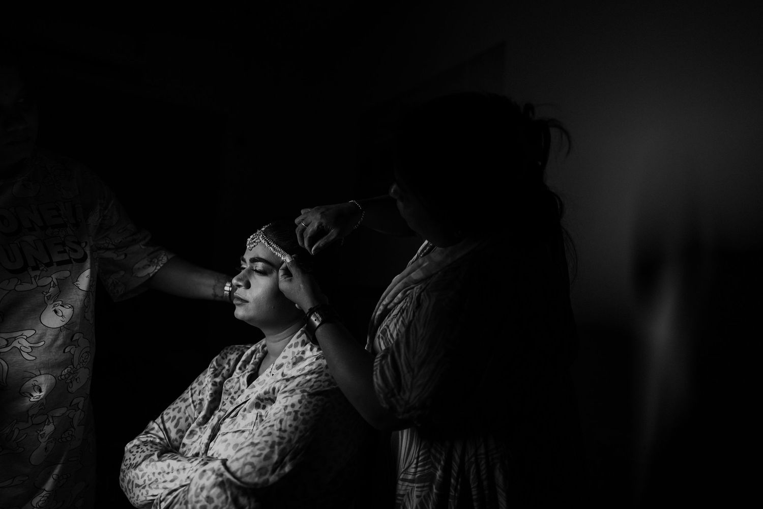 A sequence of black and white wedding photographs showing candid moments during a celebration.