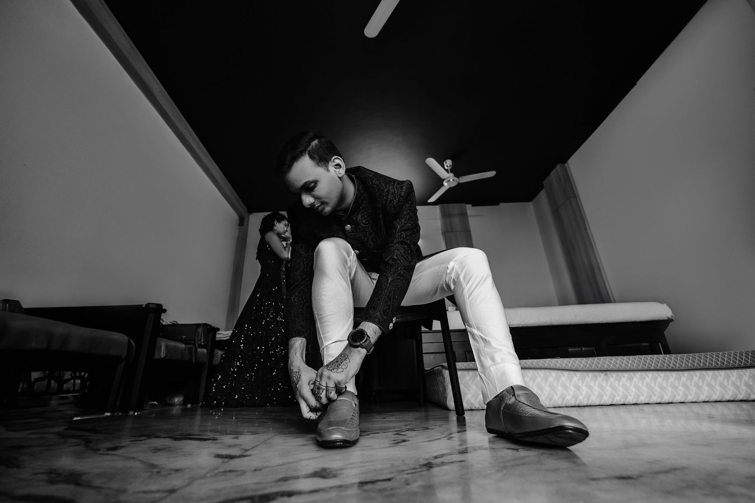 A series of black and white photographs showing someone dancing and moving on a wooden floor.