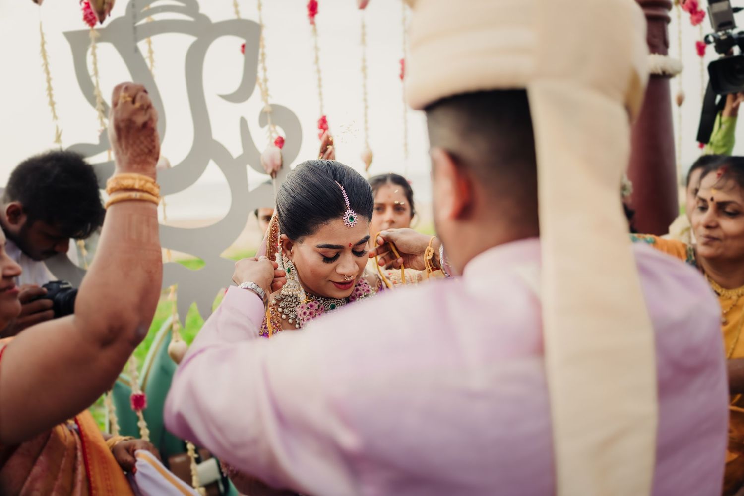 Traditional Indian wedding ceremony with participants in colorful attire performing cultural rituals and customs.