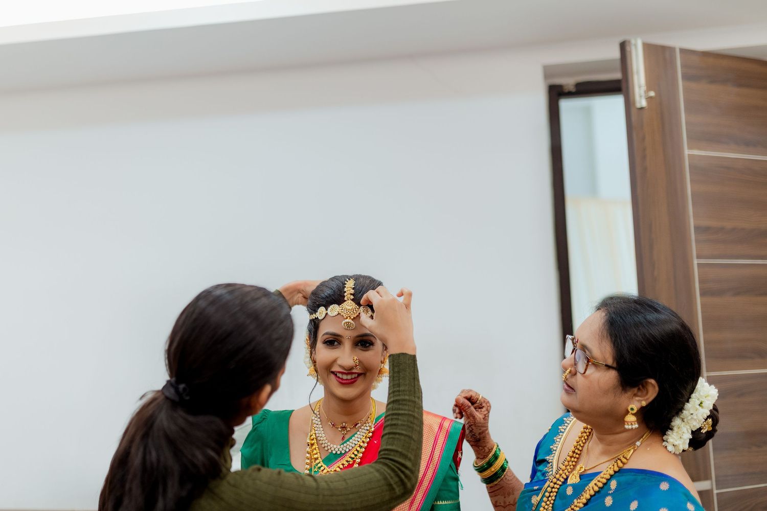 People taking photos with cameras and phones at a festive indoor gathering.