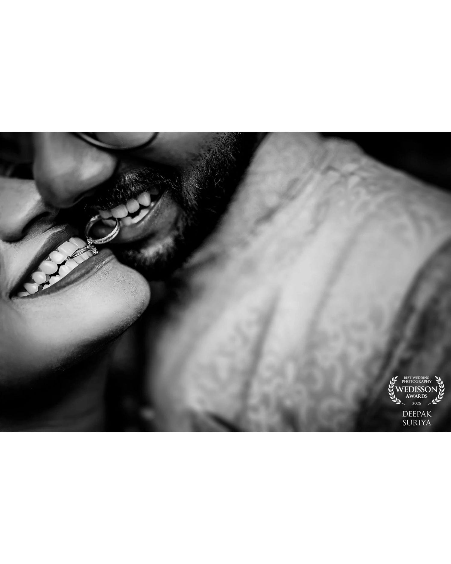 Black and white close-up photo of a smiling couple sharing an intimate moment, captured by Deepak Suriya for Wedisson.