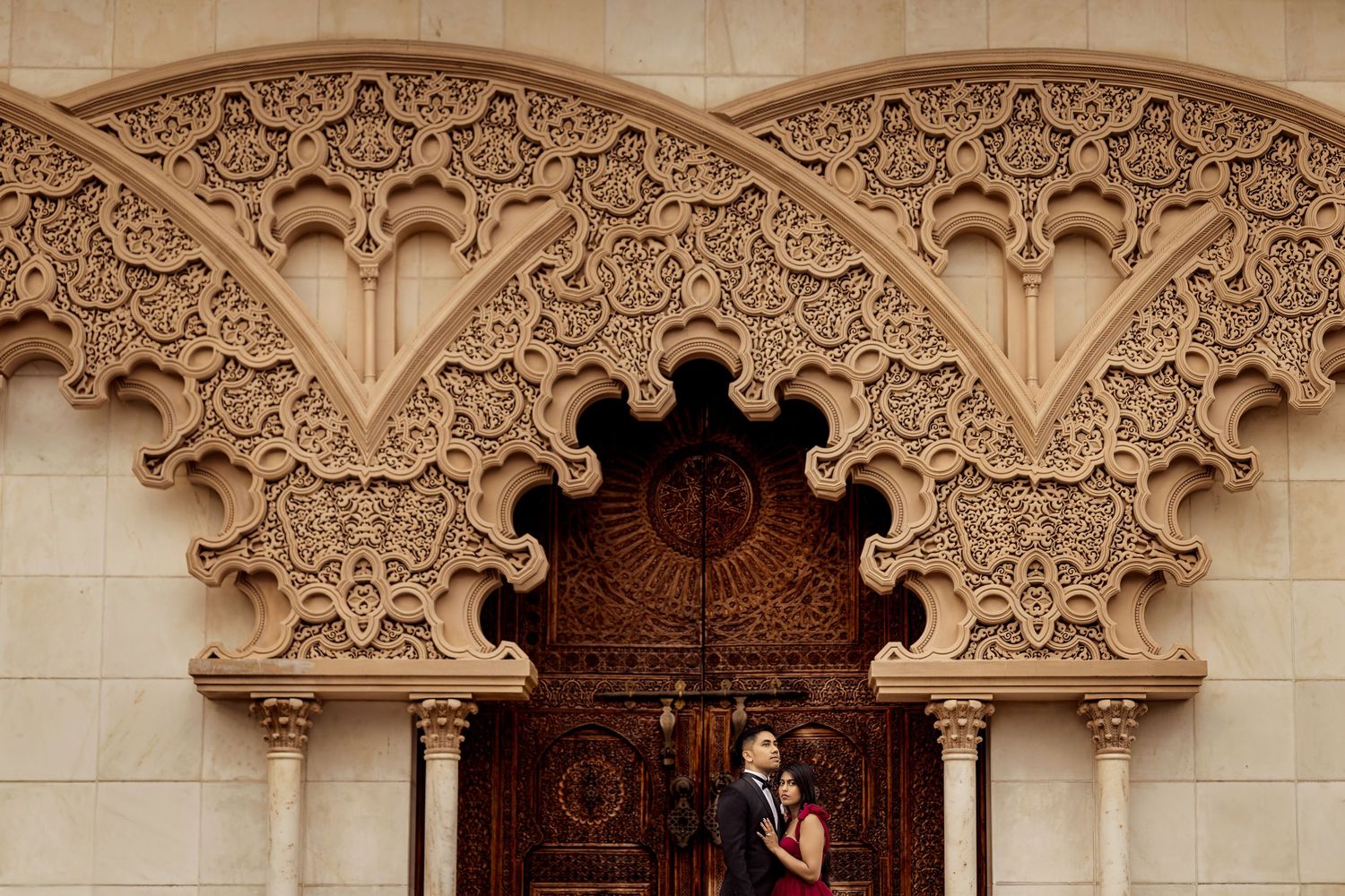 Ornate architectural details of a stone archway featuring intricate Moorish-style carvings and decorative patterns.