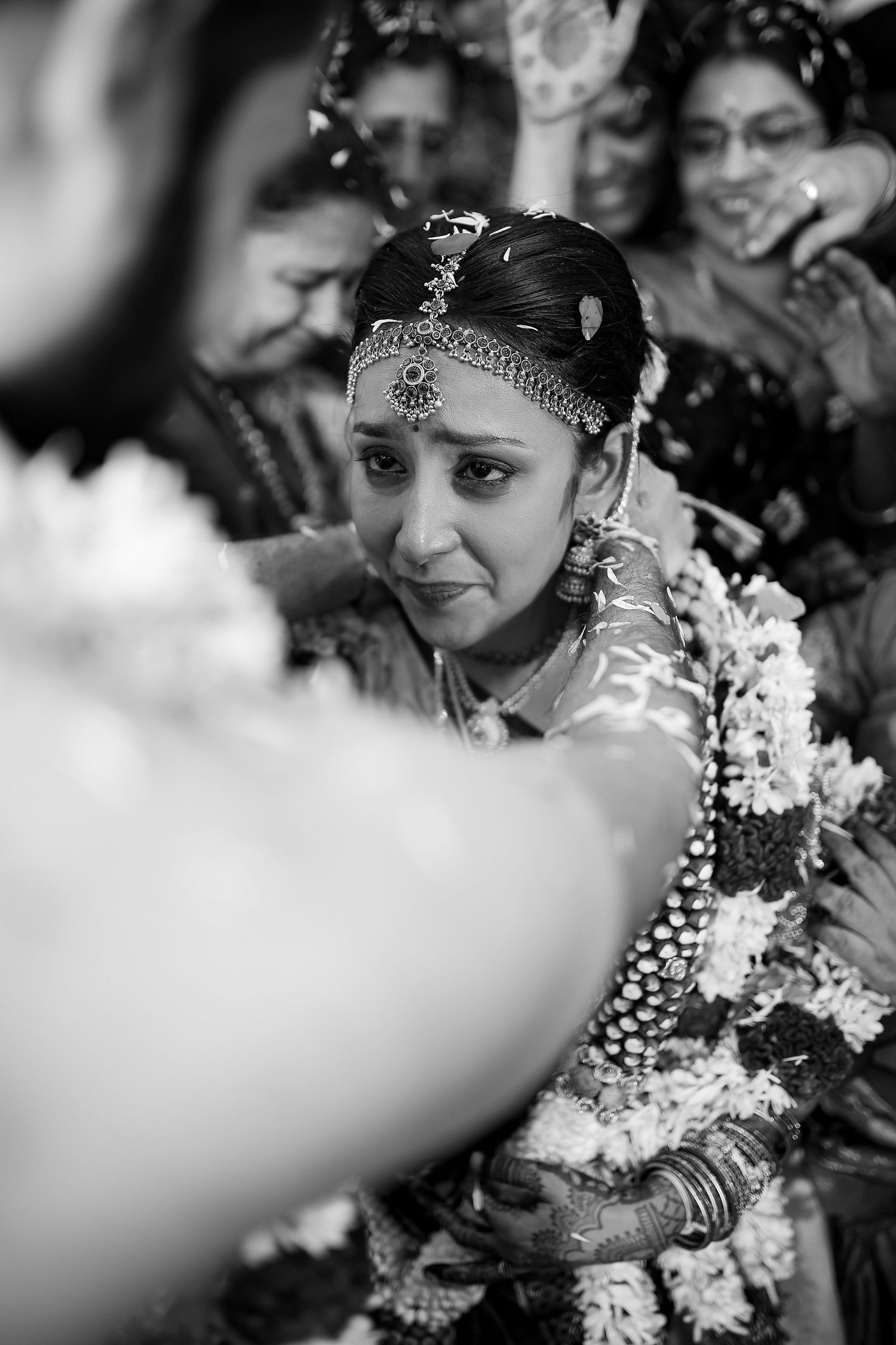 Black and white candid shots of traditional Indian wedding ceremony celebrations.
