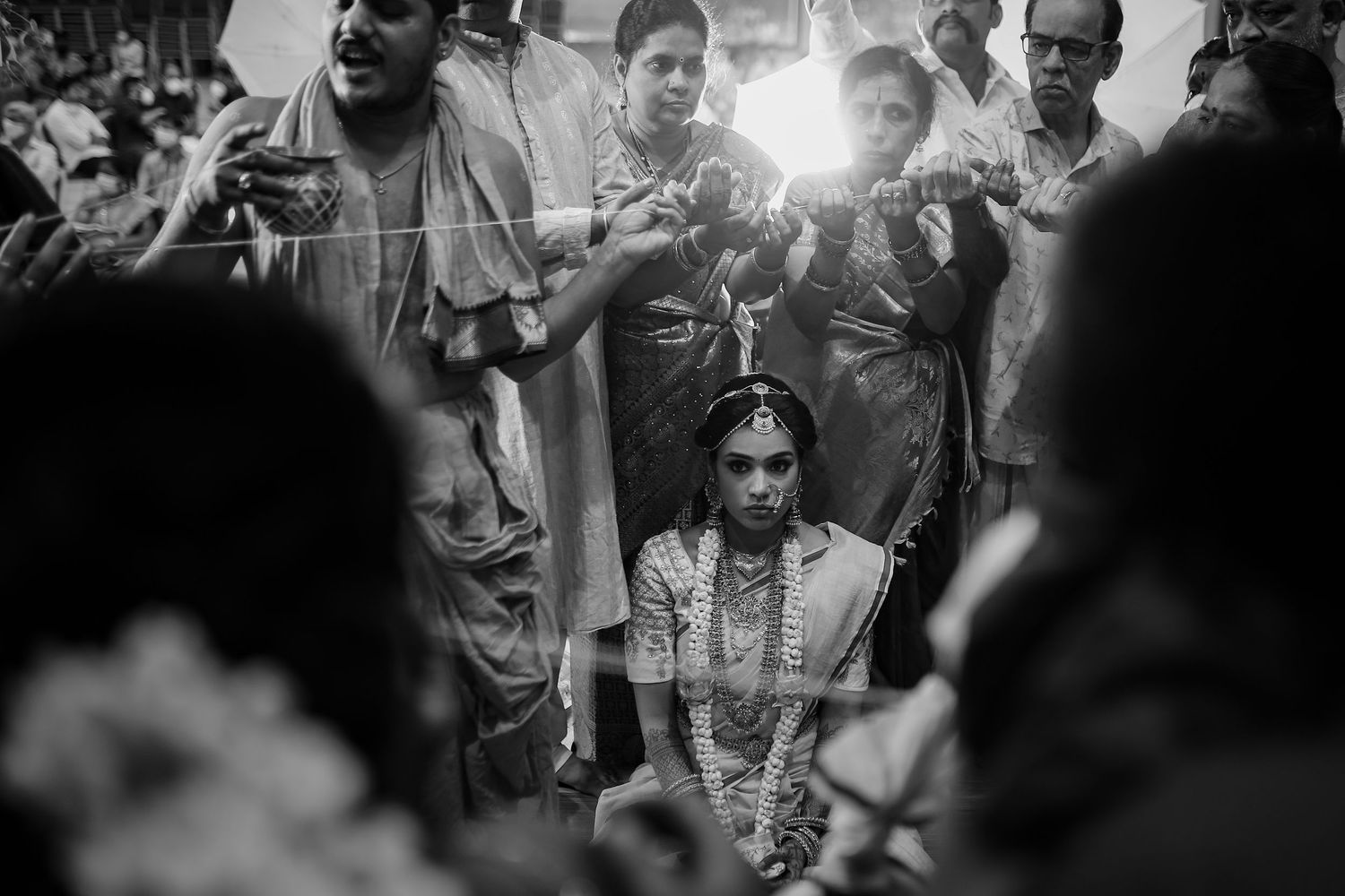 Black and white candid photo of a crowd celebrating during a festive outdoor gathering.