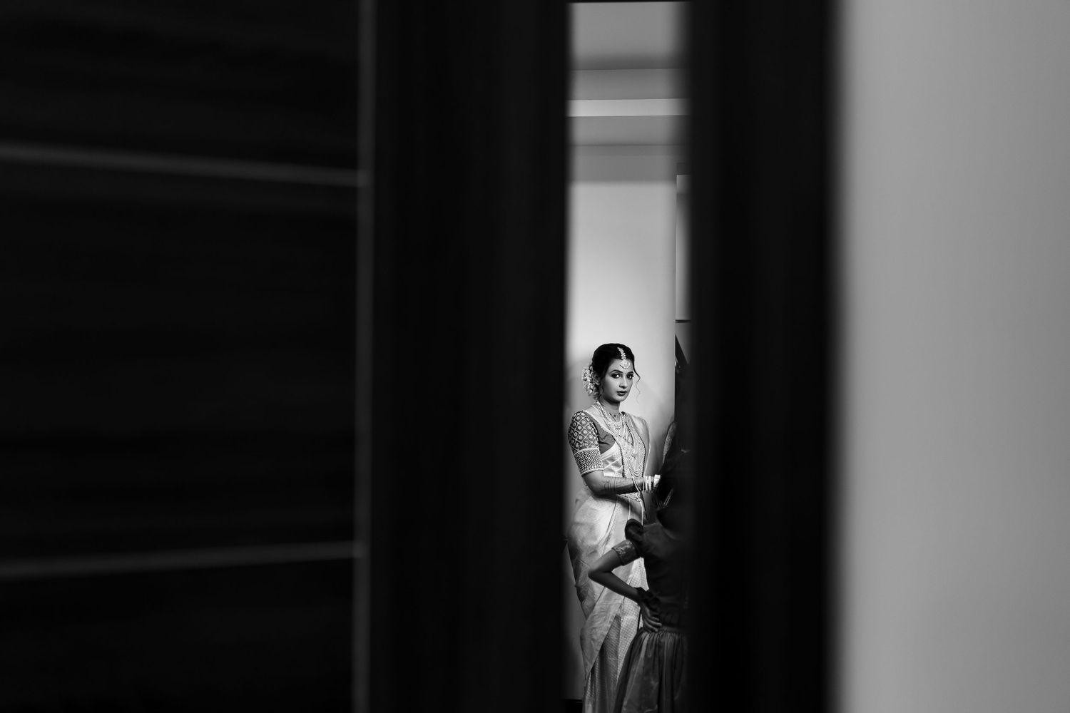 Black and white artistic photo sequence showing a figure emerging from darkness into a doorway's light.