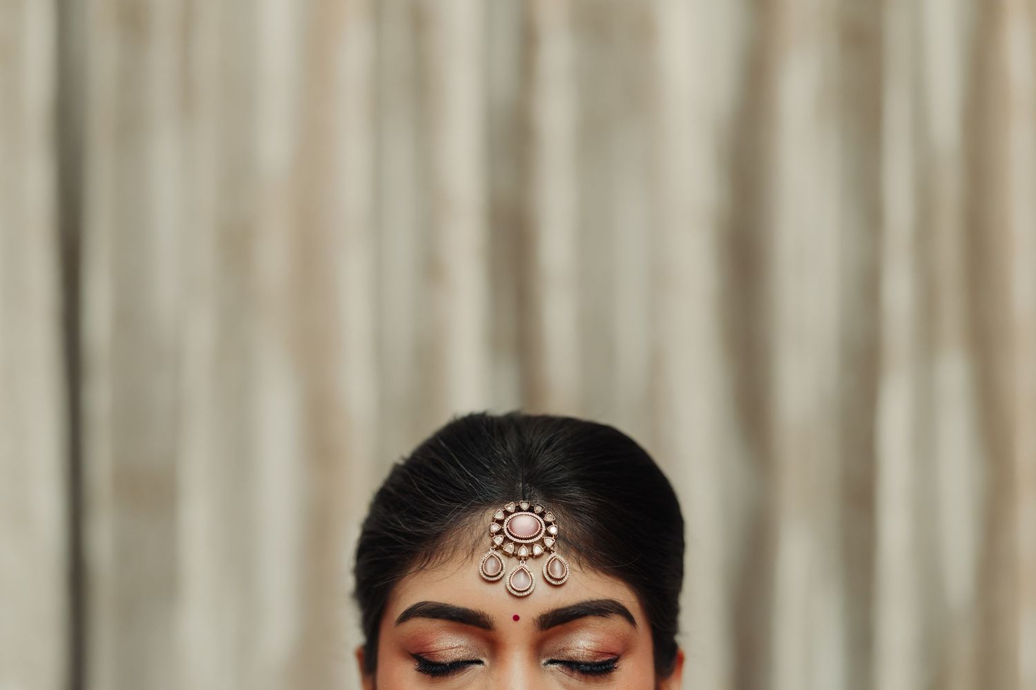 Close-up view of intricate bridal jewelry and traditional South Indian wedding attire.
