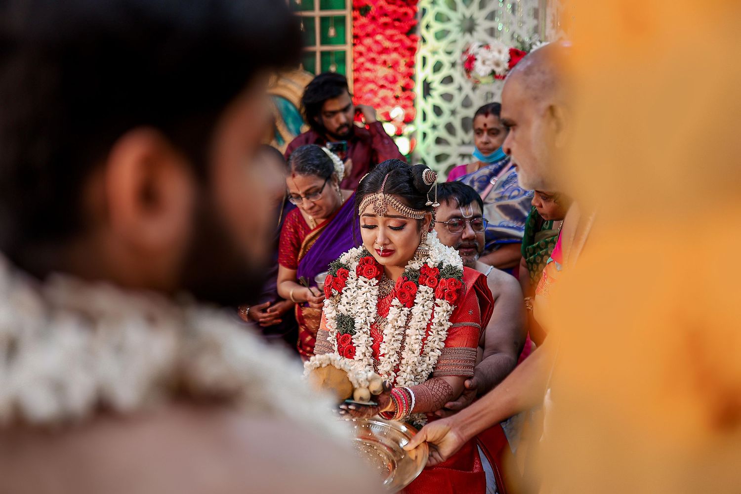 Traditional Indian wedding ceremony with red and gold decorative elements.