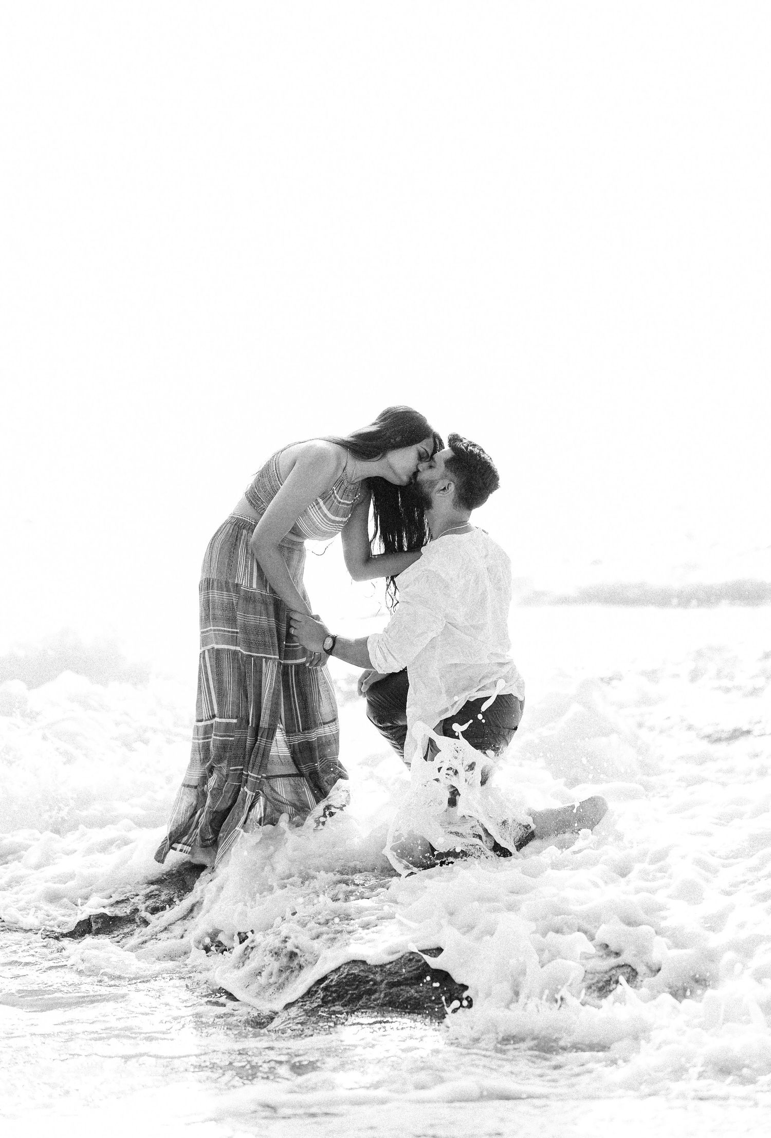 High key black and white sequence showing splashing waves at the beach.
