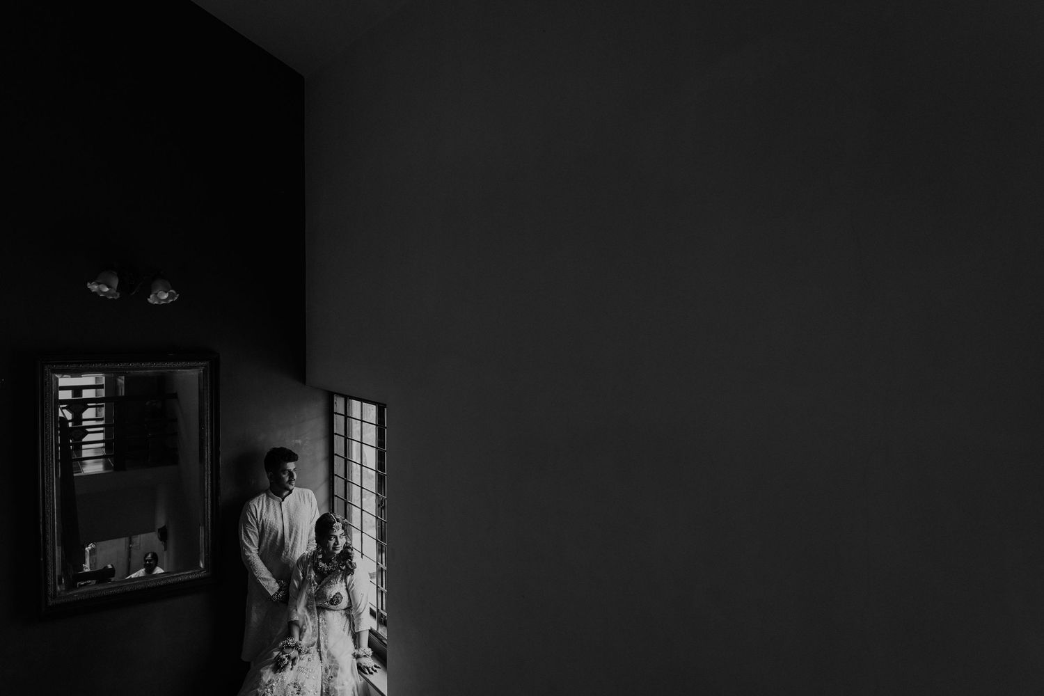 A dark and moody black and white photo series showing a person in different dramatic lighting situations.