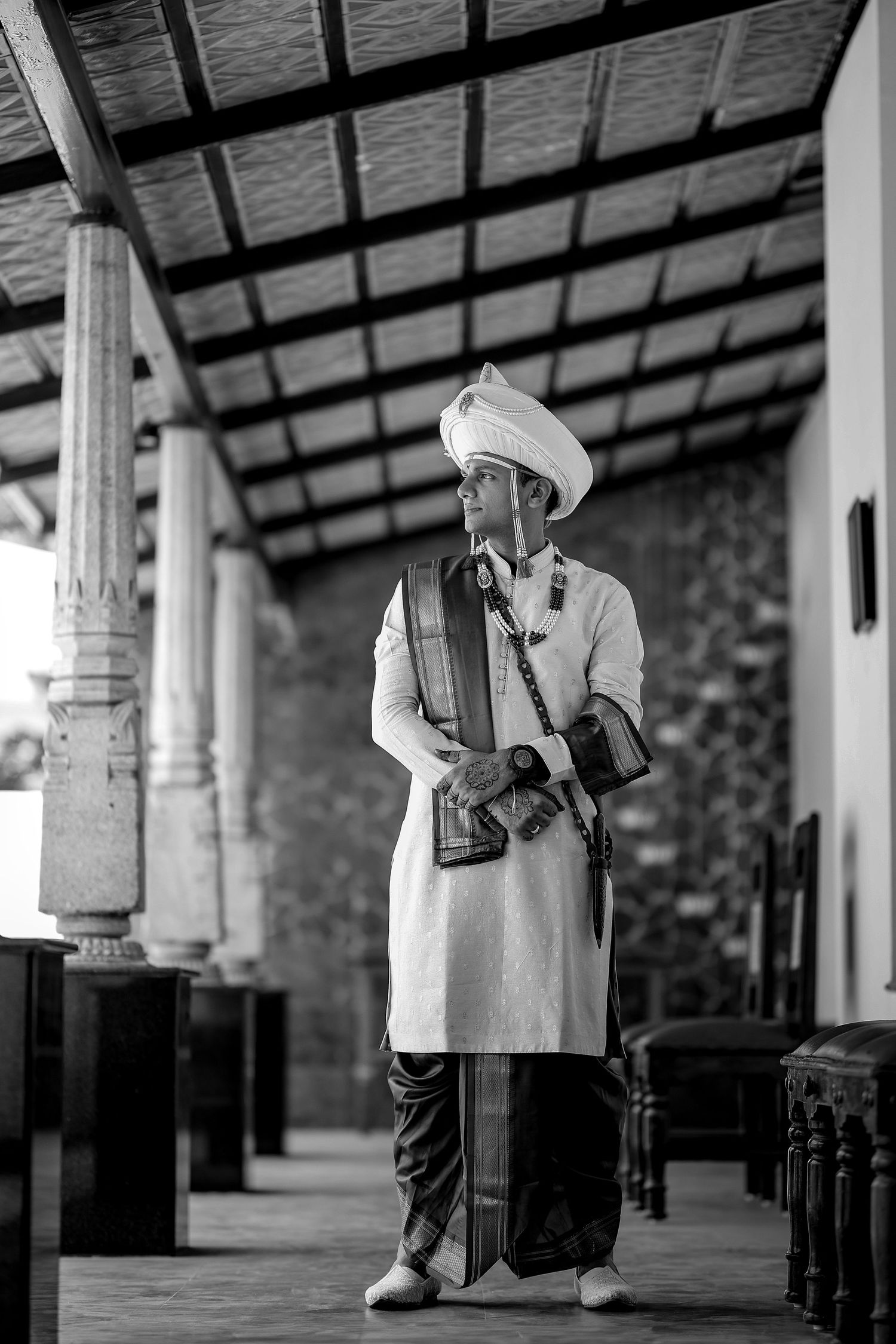 Black and white photo series showing person walking through empty train station platform with luggage.