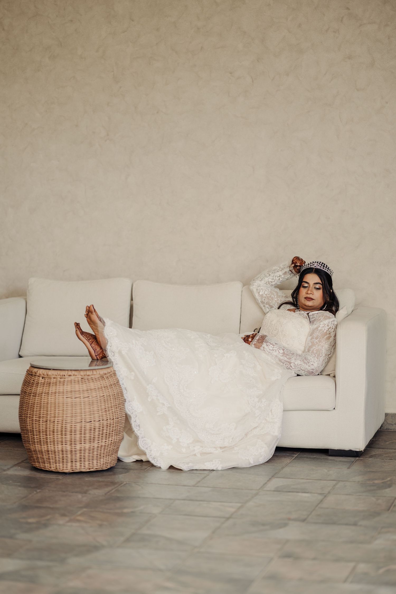 A sequence of artistic photos showing a person in white dress reclining on floor next to a woven basket.