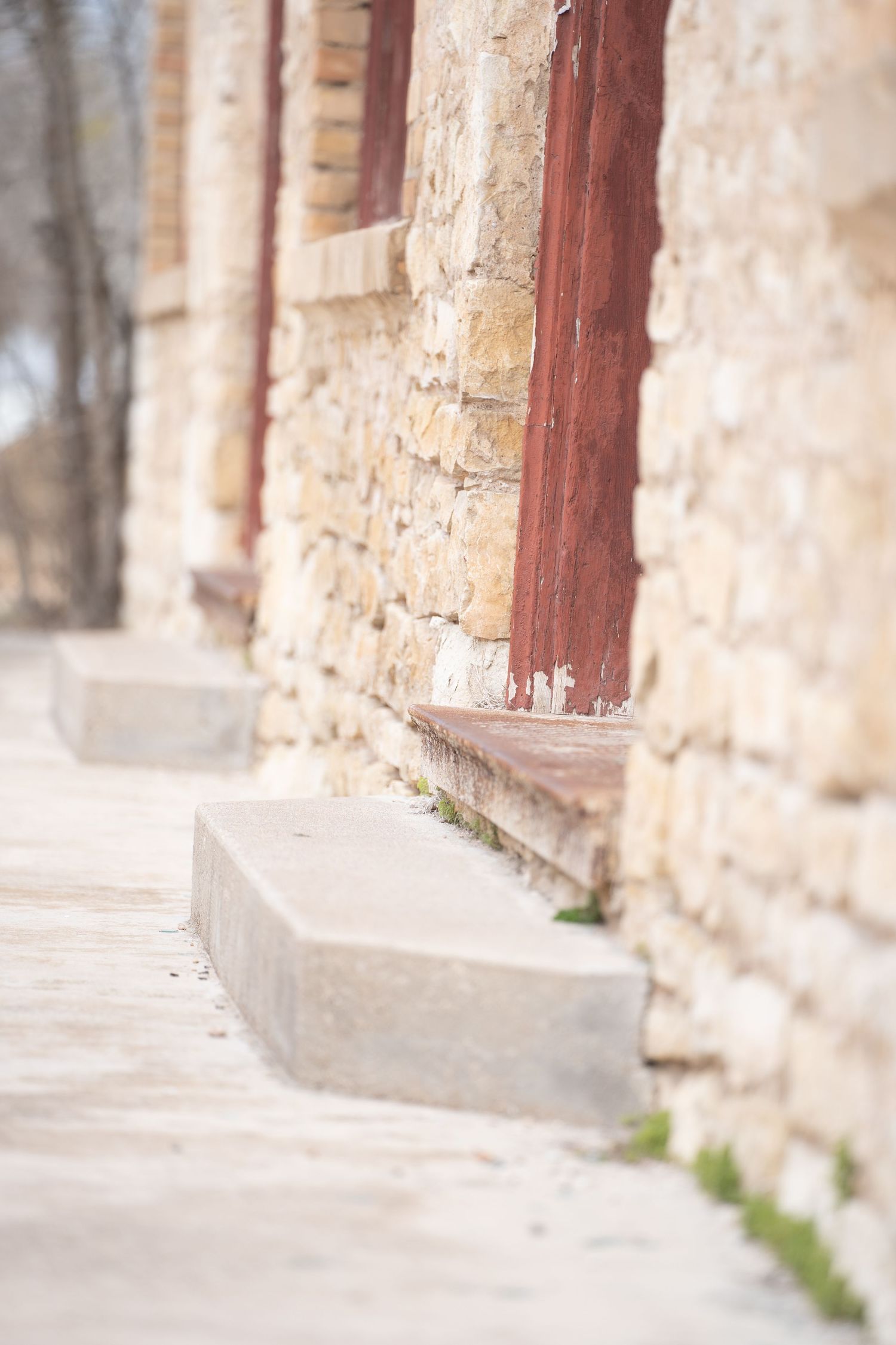 Stone wall architectural detail with wooden trim and soft focus effect.