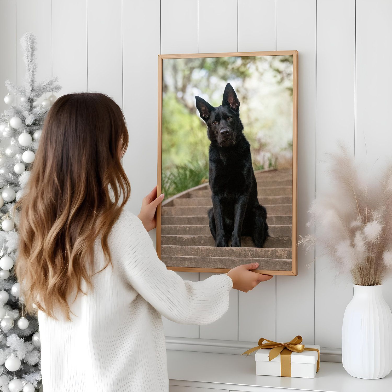 Gallery wall display featuring framed dog portraits and decorative dried flowers in a modern minimalist interior.