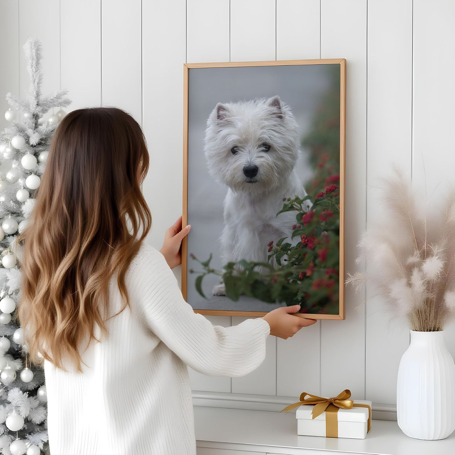 Gallery wall with framed dog portraits being arranged on white paneled wall.