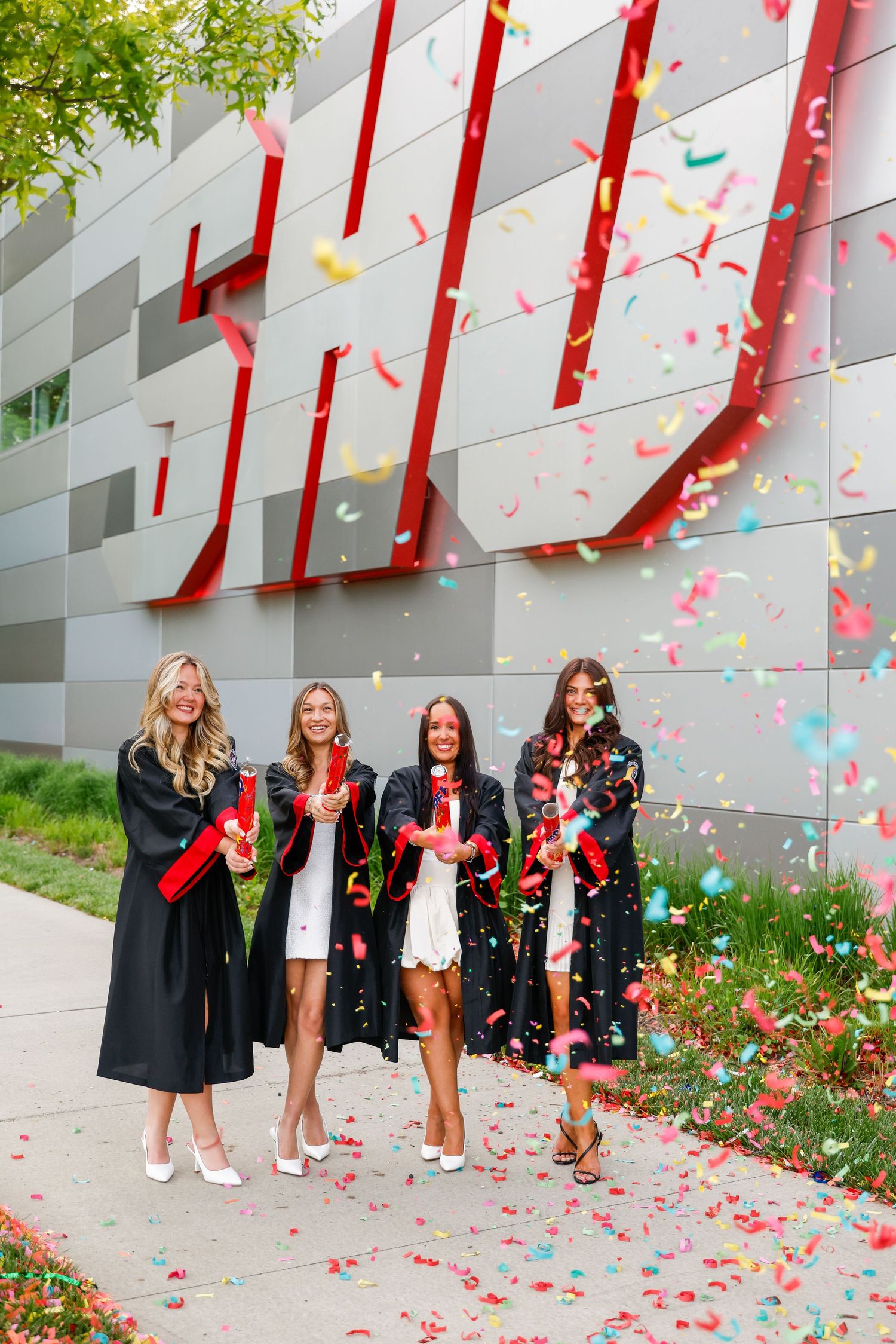 Group of graduates at Sacred Heart University using confetti cannons