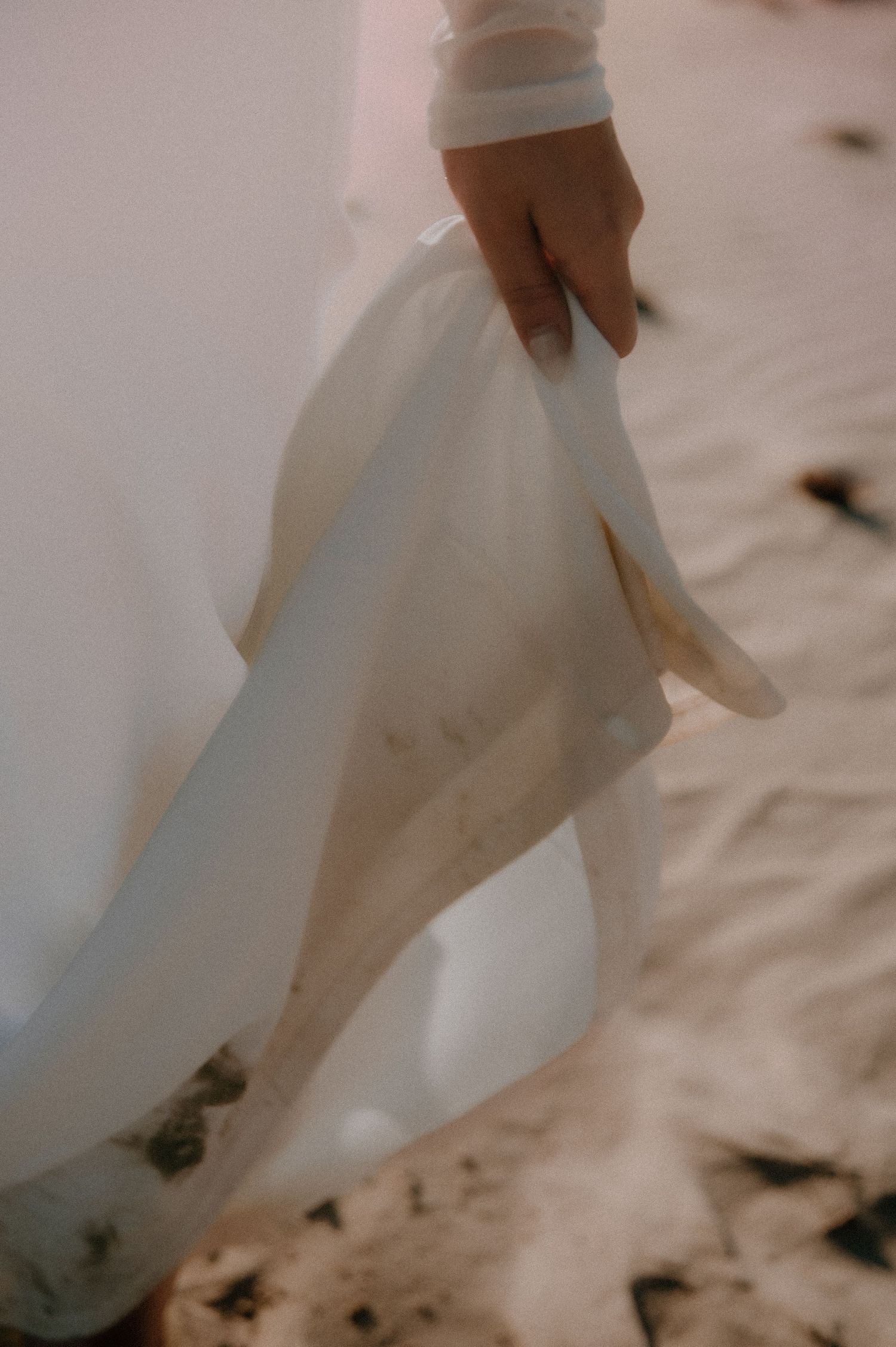 A white wedding dress skirt twirls gracefully in a close-up sequence of romantic movement.