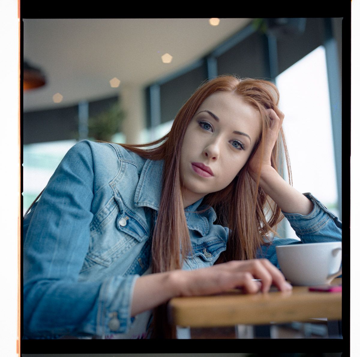 individual posing for creative portrait in cafe.