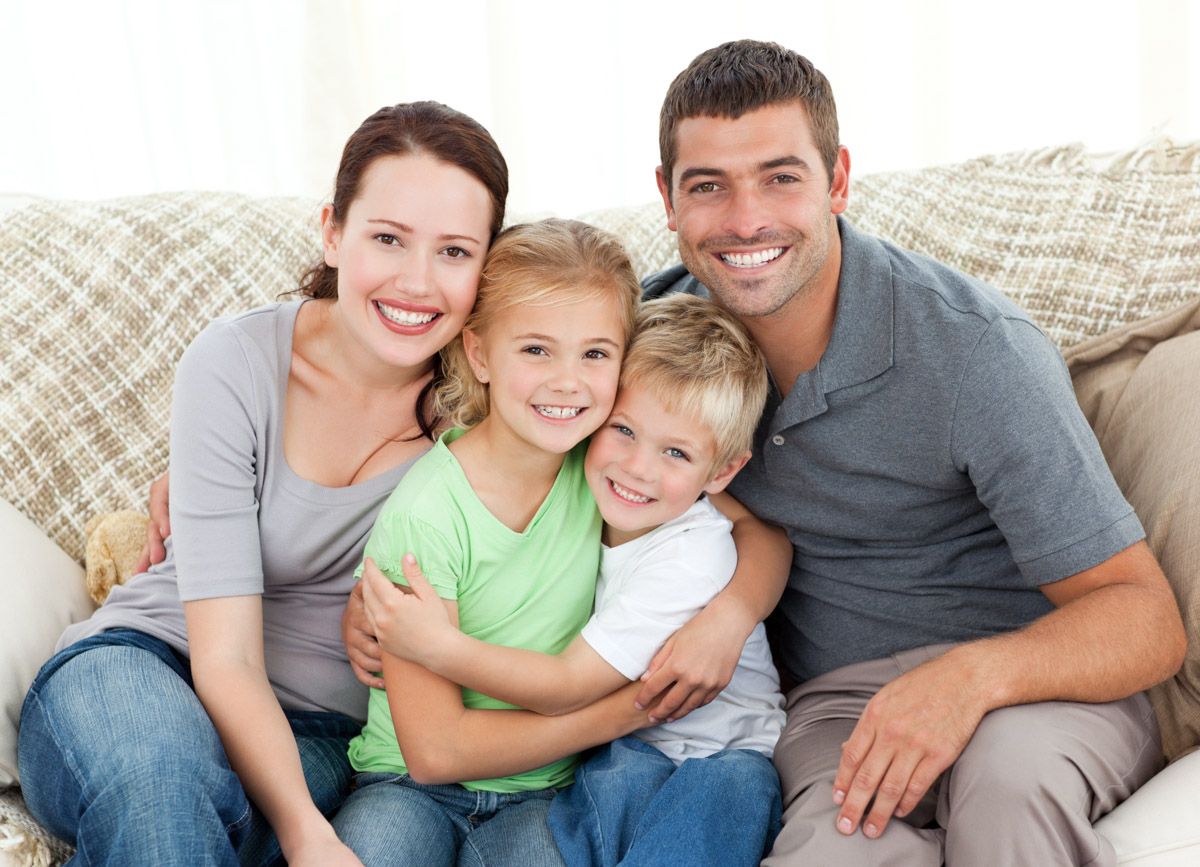 Parents and children embracing for professional portrait.