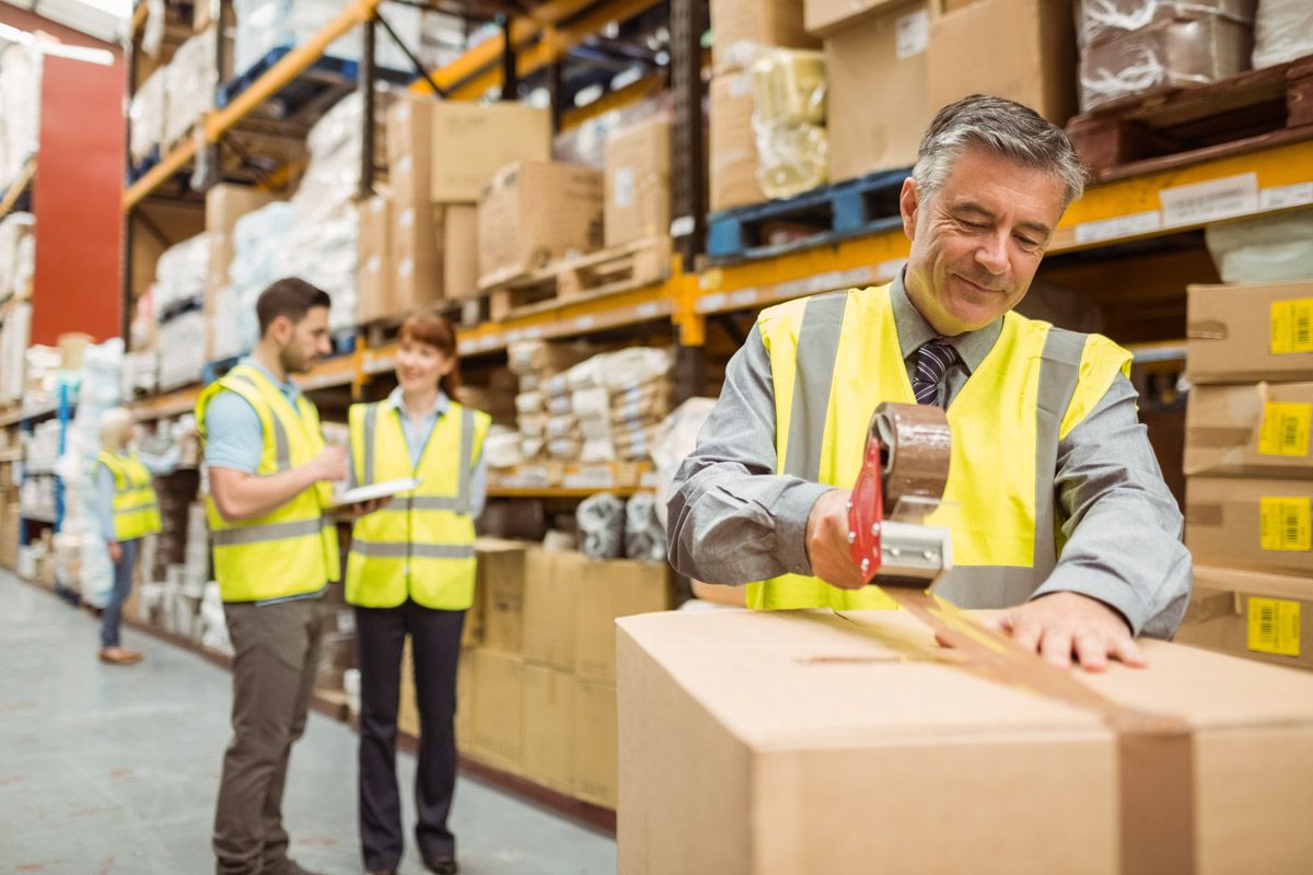 Group of employees preparing goods for shipment.